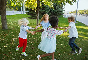 Image showing Interracial group of kids, girls and boys playing together at the park in summer day