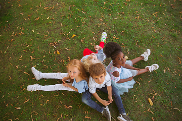 Image showing Interracial group of kids, girls and boys playing together at the park in summer day