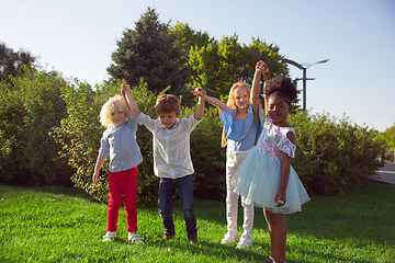 Image showing Interracial group of kids, girls and boys playing together at the park in summer day