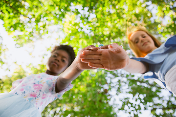 Image showing Interracial kids, friends, girls playing together at the park in summer day