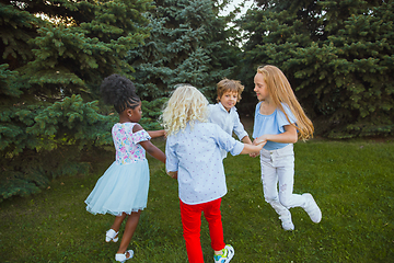 Image showing Interracial group of kids, girls and boys playing together at the park in summer day