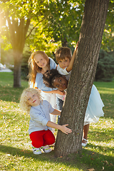 Image showing Interracial group of kids, girls and boys playing together at the park in summer day