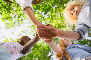 Image showing Interracial group of kids, girls and boys playing together at the park in summer day