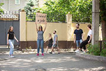 Image showing Dude with sign - woman stands protesting things that annoy him