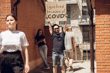 Image showing Dude with sign - man stands protesting things that annoy him