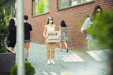 Image showing Dude with sign - woman stands protesting things that annoy him