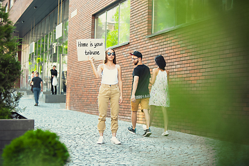 Image showing Dude with sign - woman stands protesting things that annoy him