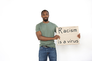 Image showing Young man protesting isolated on white studio background. Activism, active social position, protest, actual problems.