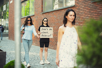 Image showing Dude with sign - woman stands protesting things that annoy him