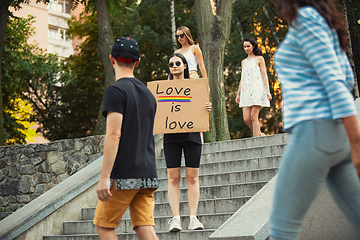 Image showing Dude with sign - woman stands protesting things that annoy him