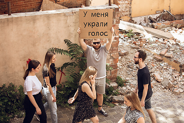 Image showing Dude with sign - man stands protesting things that annoy him