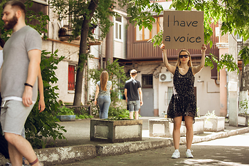 Image showing Dude with sign - woman stands protesting things that annoy him