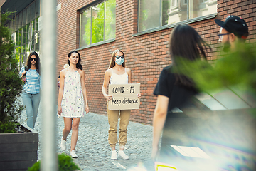 Image showing Dude with sign - woman stands protesting things that annoy him