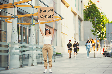 Image showing Dude with sign - woman stands protesting things that annoy him