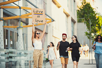 Image showing Dude with sign - woman stands protesting things that annoy him