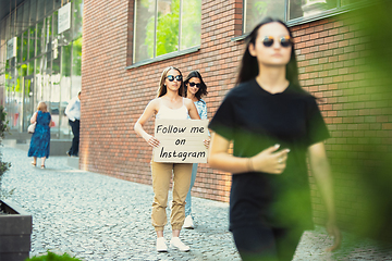 Image showing Dude with sign - woman stands protesting things that annoy him