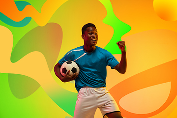 Image showing African soccer, football player portrait isolated on bright, modern illustrated background.