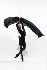 Image showing Young and graceful ballet dancer in minimal black style isolated on white studio background