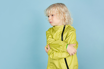 Image showing Portrait of beautiful caucasian little boy isolated on blue studio background