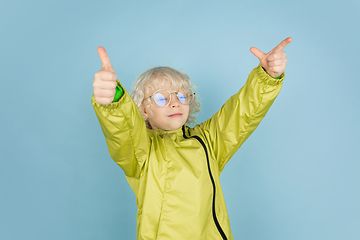 Image showing Portrait of beautiful caucasian little boy isolated on blue studio background