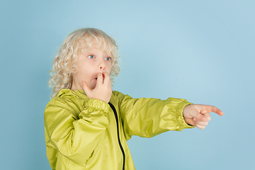 Image showing Portrait of beautiful caucasian little boy isolated on blue studio background