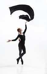 Image showing Young and graceful ballet dancer in minimal black style isolated on white studio background