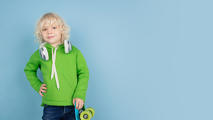 Image showing Portrait of beautiful caucasian little boy isolated on blue studio background