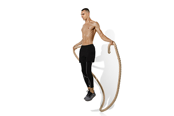 Image showing Beautiful young male athlete practicing on white studio background with shadows