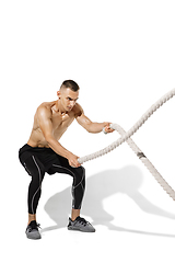 Image showing Beautiful young male athlete practicing on white studio background with shadows