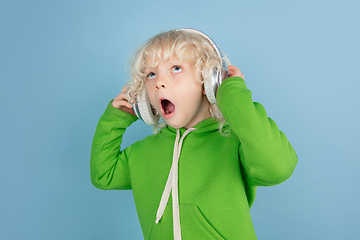 Image showing Portrait of beautiful caucasian little boy isolated on blue studio background