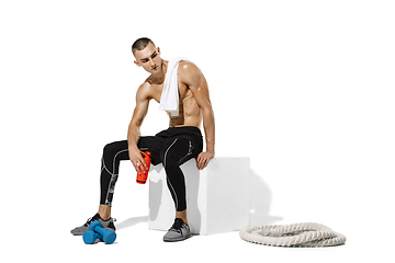 Image showing Beautiful young male athlete practicing on white studio background with shadows