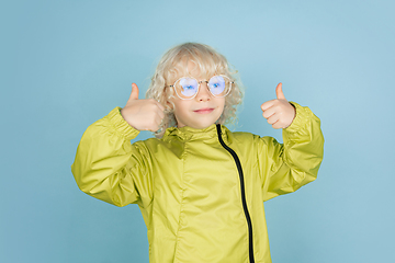 Image showing Portrait of beautiful caucasian little boy isolated on blue studio background