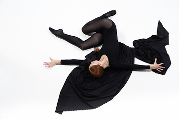 Image showing Young and graceful ballet dancer in minimal black style isolated on white studio background