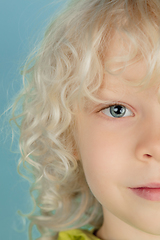 Image showing Portrait of beautiful caucasian little boy isolated on blue studio background