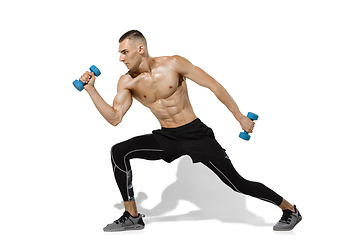 Image showing Beautiful young male athlete practicing on white studio background with shadows