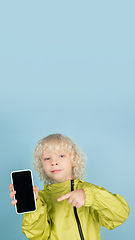 Image showing Portrait of beautiful caucasian little boy isolated on blue studio background