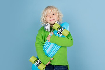 Image showing Portrait of beautiful caucasian little boy isolated on blue studio background