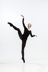 Image showing Young and graceful ballet dancer in minimal black style isolated on white studio background
