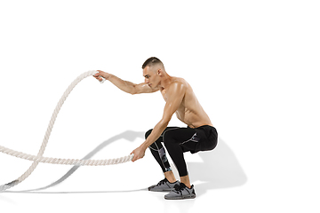 Image showing Beautiful young male athlete practicing on white studio background with shadows