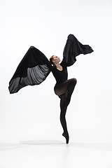 Image showing Young and graceful ballet dancer in minimal black style isolated on white studio background