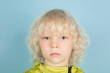 Image showing Portrait of beautiful caucasian little boy isolated on blue studio background