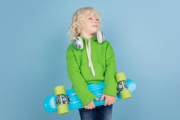 Image showing Portrait of beautiful caucasian little boy isolated on blue studio background