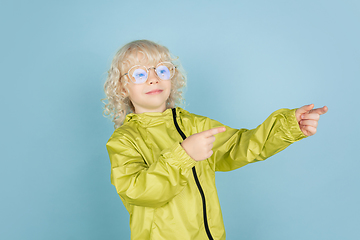 Image showing Portrait of beautiful caucasian little boy isolated on blue studio background