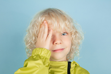 Image showing Portrait of beautiful caucasian little boy isolated on blue studio background