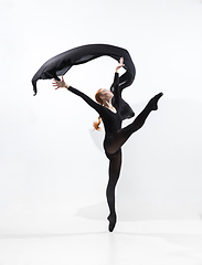 Image showing Young and graceful ballet dancer in minimal black style isolated on white studio background