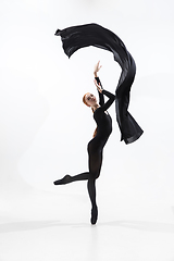 Image showing Young and graceful ballet dancer in minimal black style isolated on white studio background