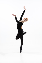 Image showing Young and graceful ballet dancer in minimal black style isolated on white studio background