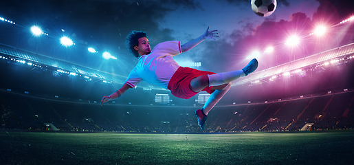 Image showing Football or soccer player on full stadium and flashlights background