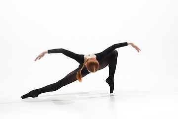 Image showing Young and graceful ballet dancer in minimal black style isolated on white studio background