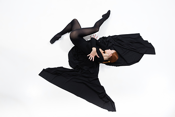 Image showing Young and graceful ballet dancer in minimal black style isolated on white studio background